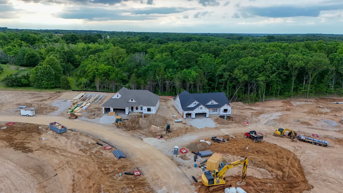 Aerial view of new homes under construction near wooded lots at The Reserve at Wildwood in Wildwood, MO