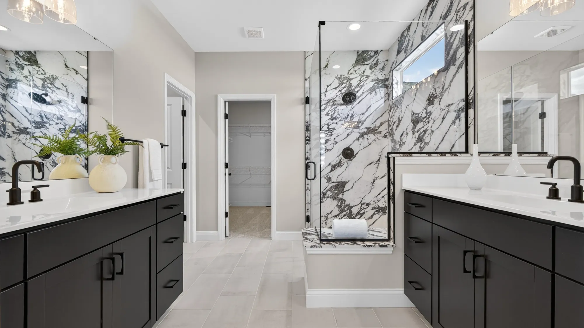 McKelvey Homes owner's suite bathroom with dual vanities and walk-in shower